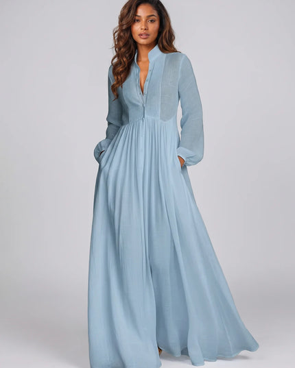 Woman wearing a light blue dress against a plain background