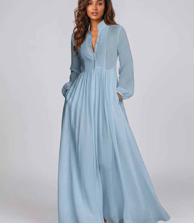 Woman wearing a light blue dress against a plain background