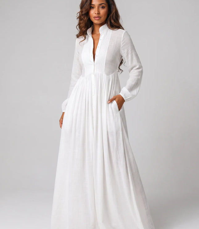 Woman wearing a long white dress against a plain background