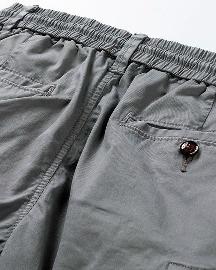 Close-up of cargo shorts waistband with brown button and drawstring