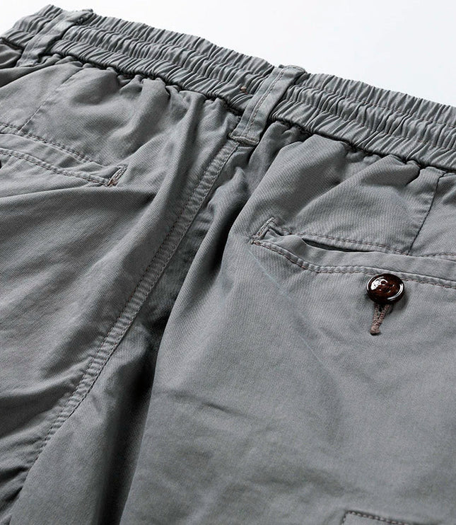 Close-up of cargo shorts waistband with brown button and drawstring