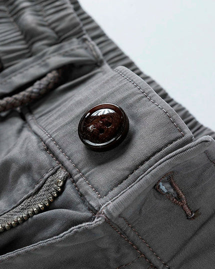 Detail view of cargo shorts pocket with metal button closure