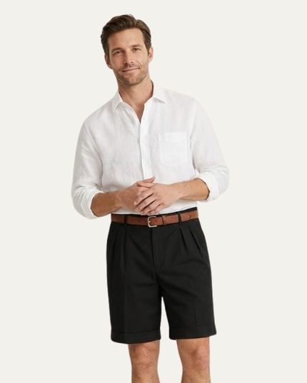 Black pleated shorts styled with white shirt and brown belt on model