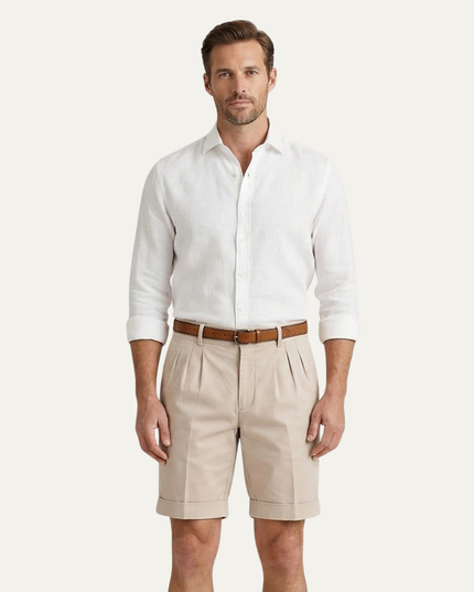 Men's beige pleated chino shorts styled with white shirt and brown belt