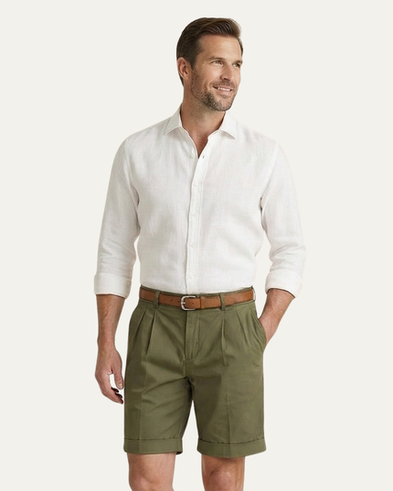 Men's olive pleated shorts styled with white shirt and brown belt