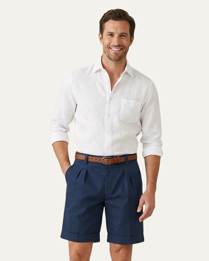 Navy pleated shorts on model with white shirt and brown leather belt
