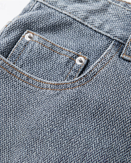 Macro detail of textured weave and stitching on denim shorts