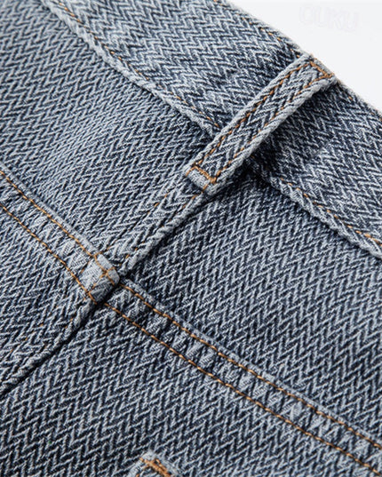 Rolled cuff detail on light blue denim shorts with contrast tan stitching