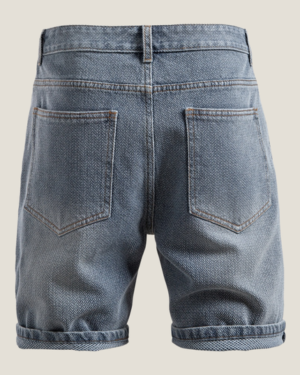 Close-up of rolled cuff detail on textured denim shorts