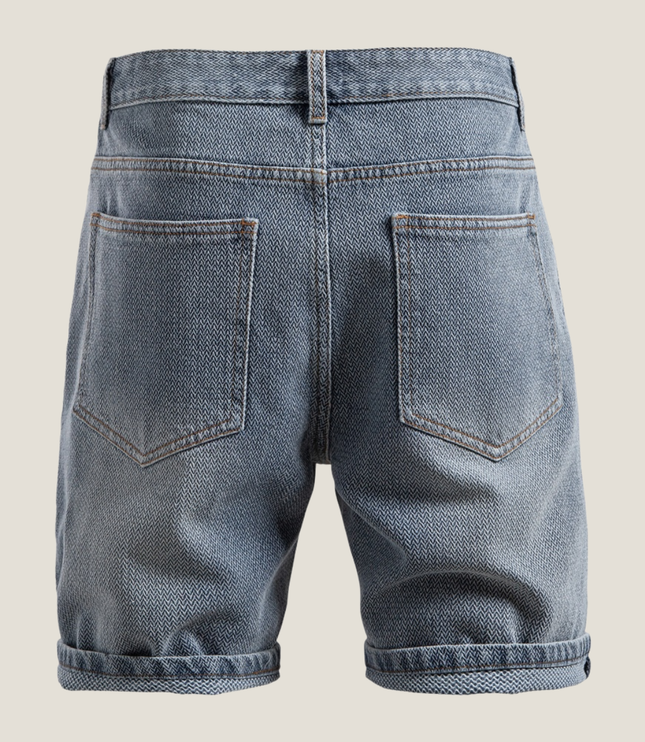Close-up of rolled cuff detail on textured denim shorts