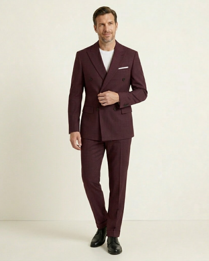 Man in blue double-breasted blazer suit standing in formal pose