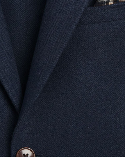 Navy herringbone tweed blazer fabric texture with brown button detail