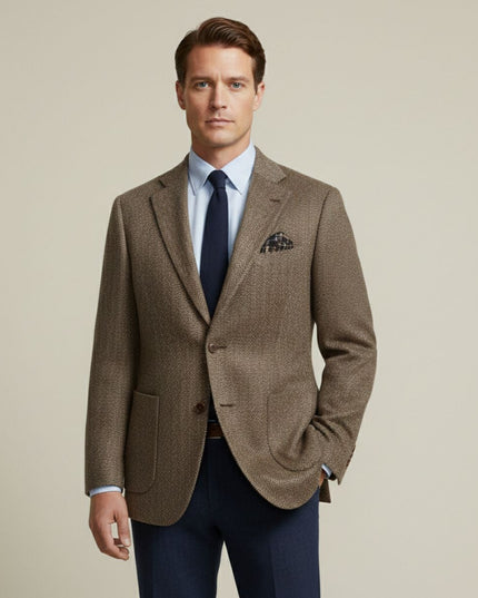 Tan herringbone tweed blazer styled with light blue shirt and navy tie