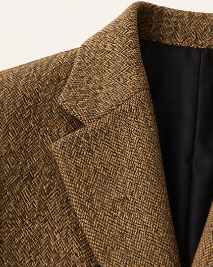 Close-up of tan herringbone wool texture and notched lapel detail