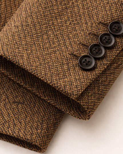 Black button cuff detail on tan herringbone wool blazer sleeve