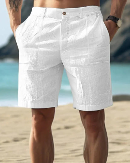 White men's linen flat front knee length shorts with button waist on beach