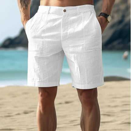 White men's linen flat front knee length shorts with button waist on beach