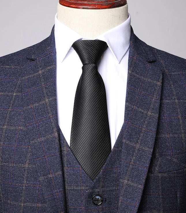 Close-up of navy plaid blazer with subtle windowpane pattern and button detail