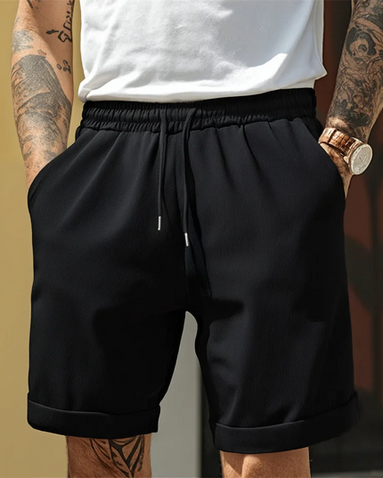 Black relaxed pull-on shorts with elastic waist and visible turnup cuff detail
