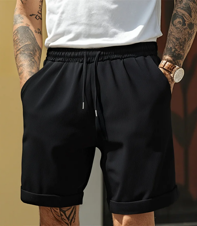 Black relaxed pull-on shorts with elastic waist and visible turnup cuff detail