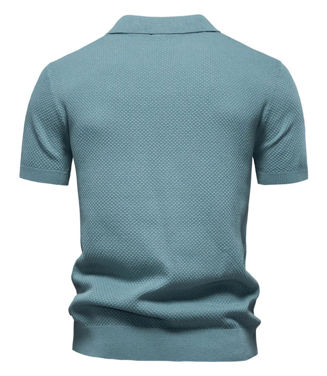 Back view of slate blue polo shirt showing textured knit pattern and short sleeves