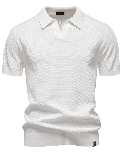 White textured short sleeve polo with spread collar and ribbed trim