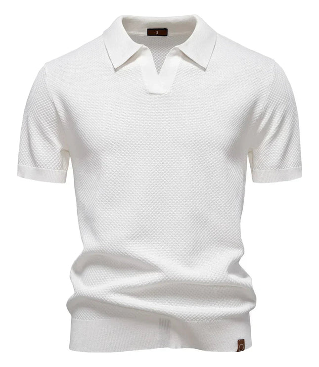 White textured short sleeve polo with spread collar and ribbed trim