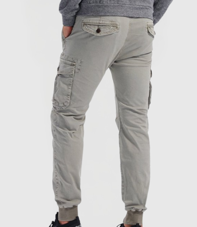 Back view of gray men's cargo pants with flap pockets and tapered fit
