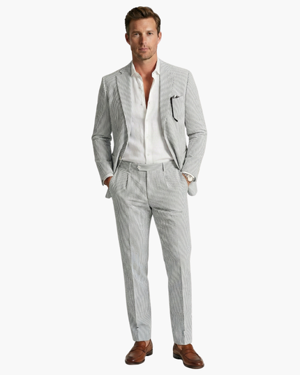 Full-length gray pinstripe men's summer suit with white shirt and brown leather shoes
