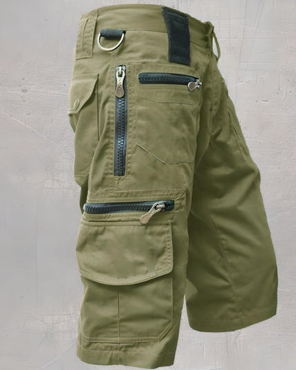 Olive green tactical cargo shorts with multiple zippered pockets and D-ring attachment