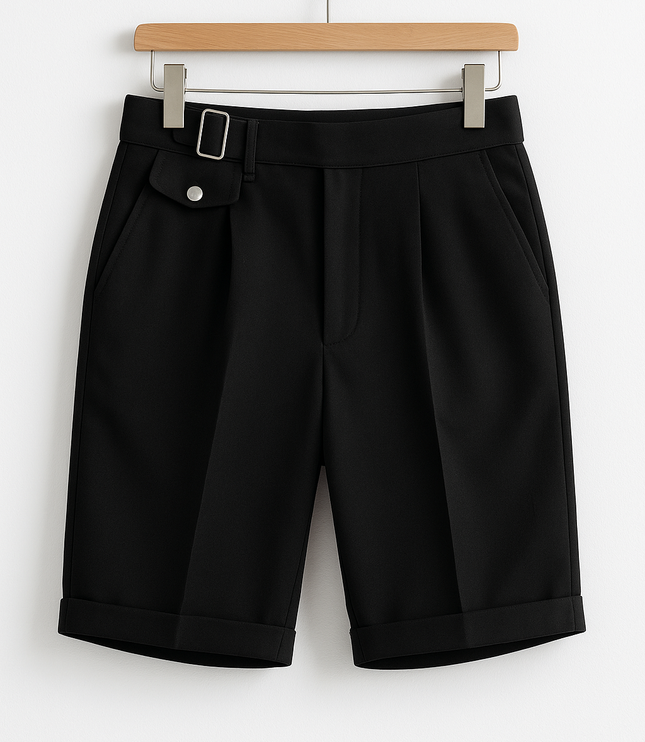 Black pleated shorts with buckle adjusters and front pockets displayed on hanger