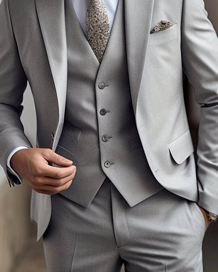 Grey three piece suit showing jacket, vest with button detail and coordinating tie