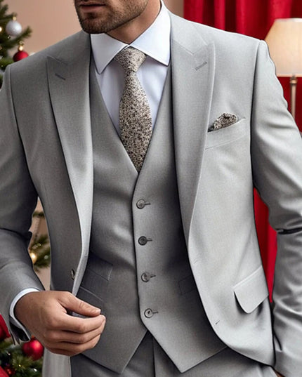 Light grey formal three piece suit styled for wedding with festive holiday backdrop