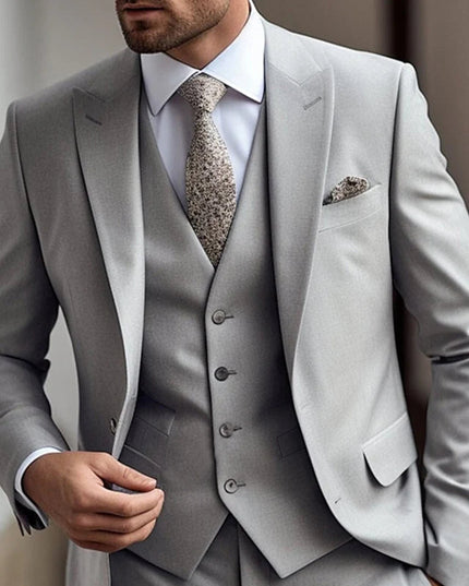 Light grey single breasted three piece suit with matching vest and patterned tie