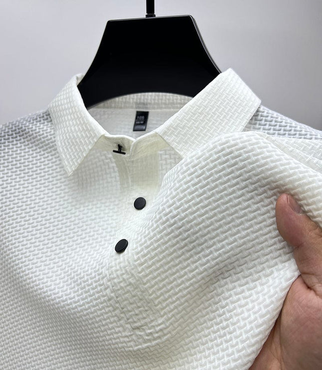 Close-up of white polo shirt waffle texture and button detail