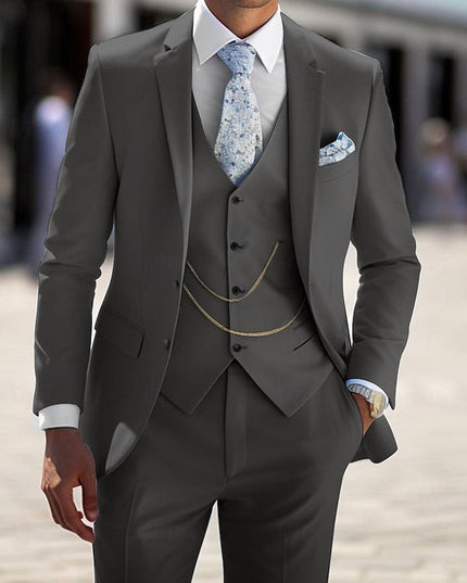 Charcoal gray formal three piece suit with single breasted blazer, vest and chain detail