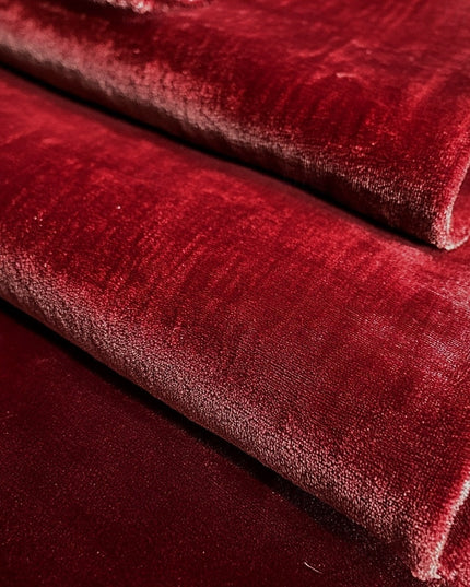 Red velvet fabric texture close-up showing plush pile detail