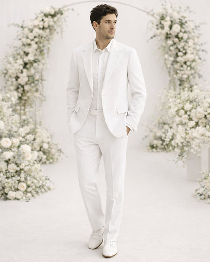 Cream white linen suit on model with white shirt for wedding guest