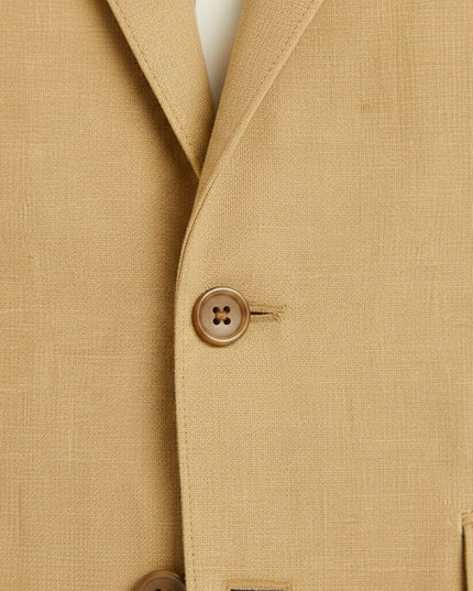Tan linen blazer close-up showing button detail and weave texture