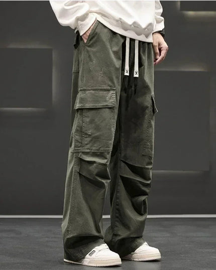 Front view of olive cargo pants with large flap pockets and relaxed fit