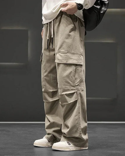 Tan cargo pocket pants with drawstring and oversized leg silhouette