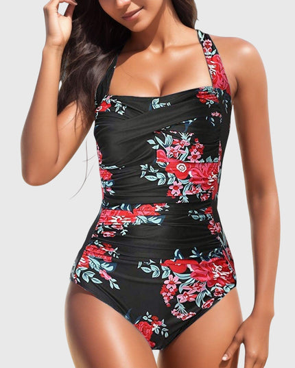 Black one-piece swimsuit with red floral design and crossover ruched bodice