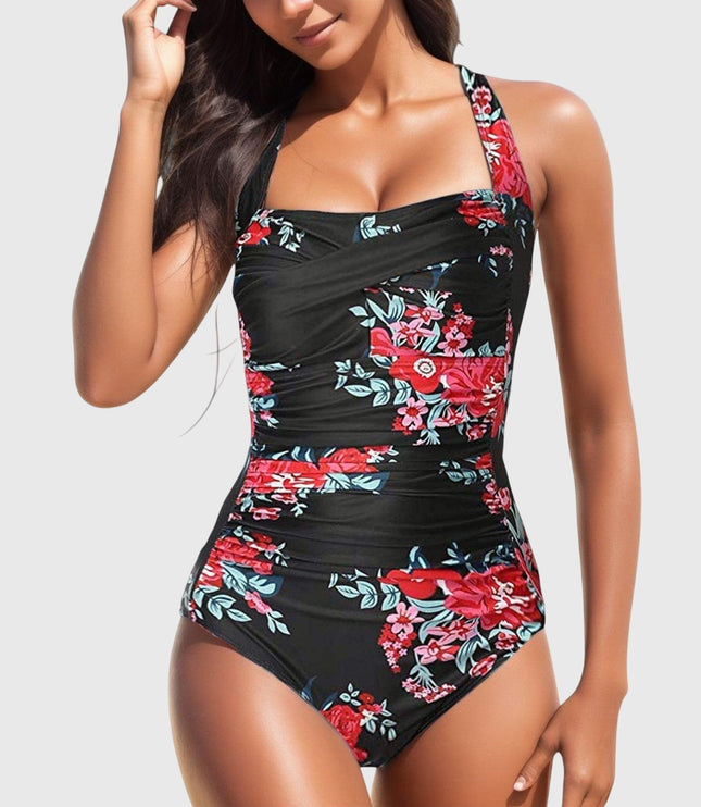 Black one-piece swimsuit with red floral design and crossover ruched bodice