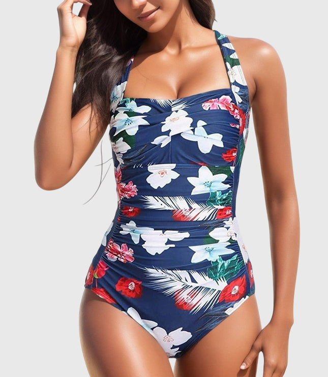 Navy one-piece swimsuit with white and red tropical flowers and ruched details