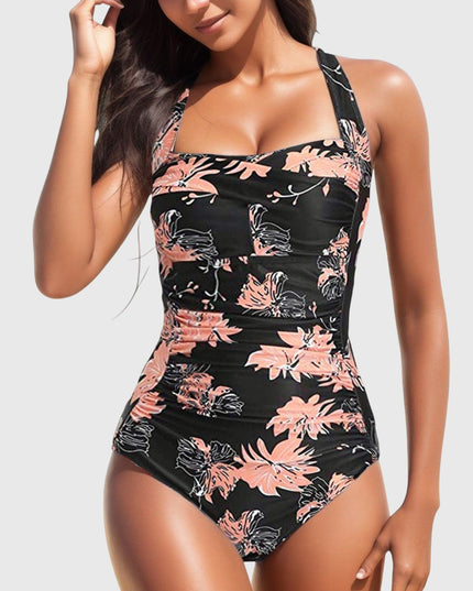 Black one-piece swimsuit with coral and pink floral print and ruching