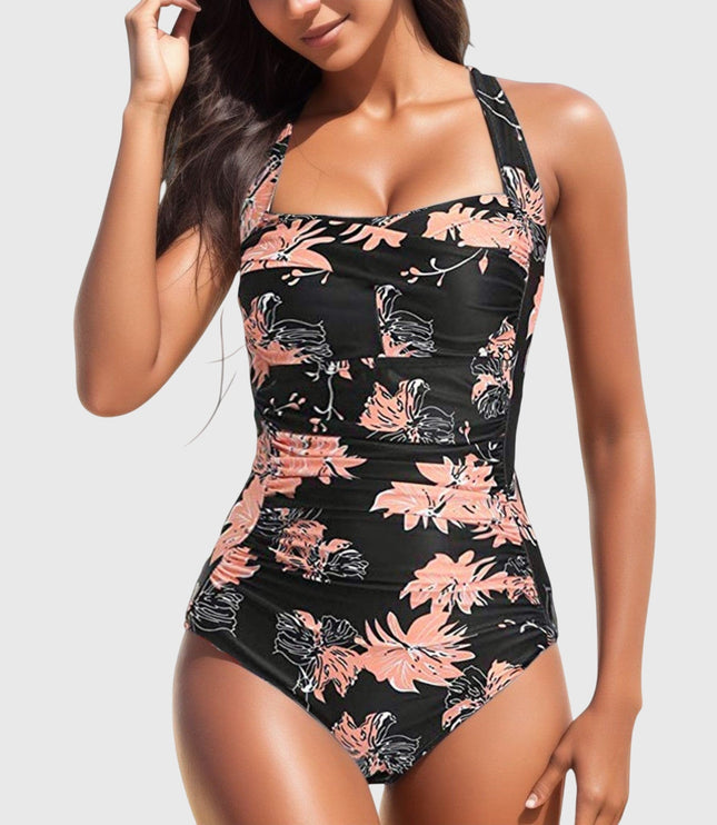 Black one-piece swimsuit with coral and pink floral print and ruching