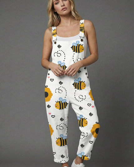 Front view of white wide leg romper with playful bee print and adjustable shoulder straps