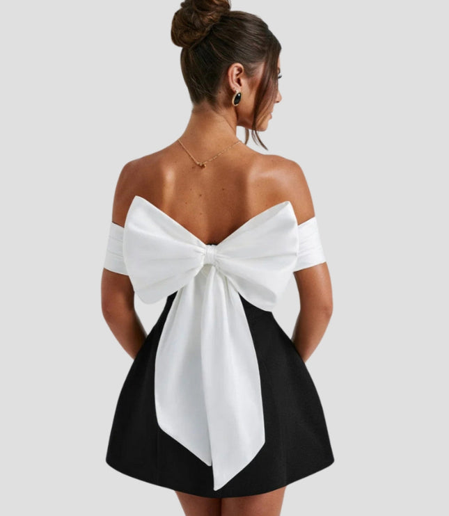 Women white and black cocktail mini dress with large bow back detail, rear view
