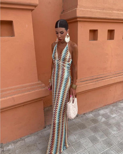 Full length view of a women's maxi dress with a colorful wave pattern and deep V-neck