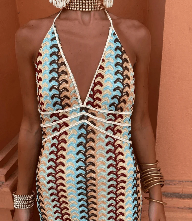 Close-up of the bodice of a women's deep V-neck maxi dress with blue, brown, and cream wave pattern